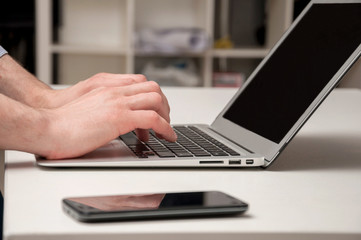 Man's hands typing on laptop. Internet surfing