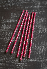 straws for drinks on a dark brown wooden background