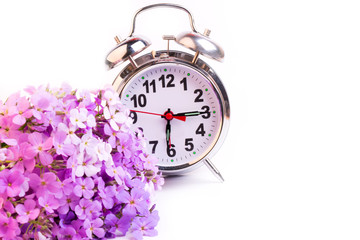 alarm clock violet flowers night morning selective soft focus