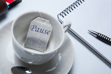 business still-life with with a cup of tea and tea bags