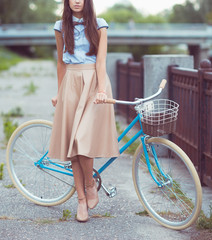 Fototapeta na wymiar Young beautiful, elegantly dressed woman with bicycle. Beauty, f