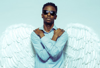 African American man with angel wings in sunglasses