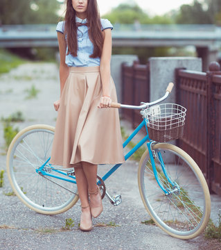 Young beautiful, elegantly dressed woman with bicycle. Beauty, f