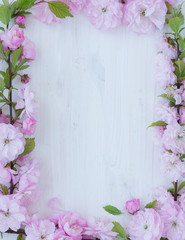 Flowers frame on wooden background