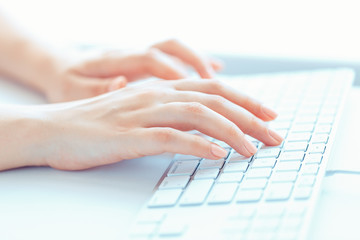 Female woman office worker typing on the keyboard