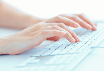 Female woman office worker typing on the keyboard