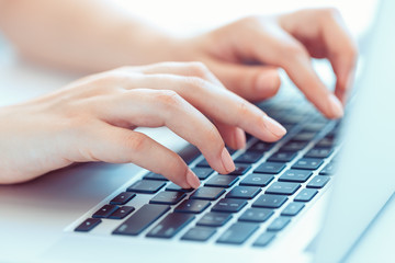 Female woman office worker typing on the keyboard