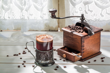 Freshly roasted ground coffee and old grinder