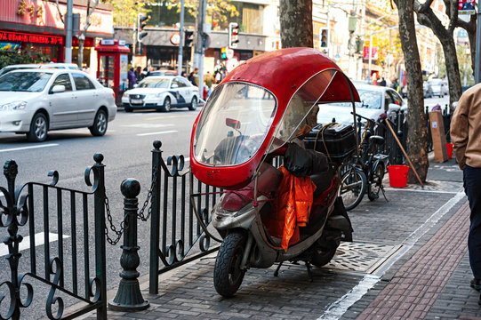 red scooter with roof in asian street
