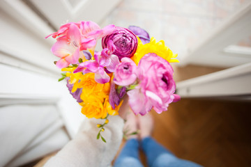 A spring gift: hand holding a bouquet of spring flowers