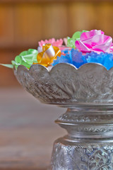plastic flower in tray with pedestal