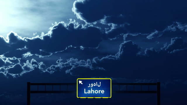 Passing under Lahore Pakistan Highway Road Sign at Night
  