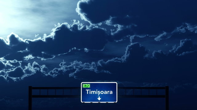 Passing under Timisoara Romania Highway Road Sign at Night
  