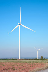 wind turbine against cloudy blue sky background