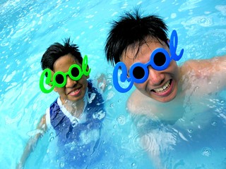 Naklejka premium Two young boys in a swimming pool with funny shades