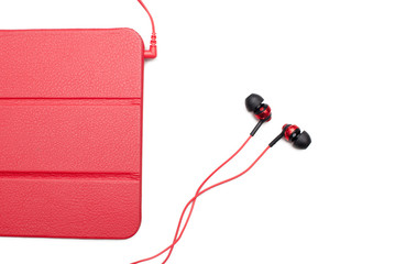 Red tablet and earphone plugs