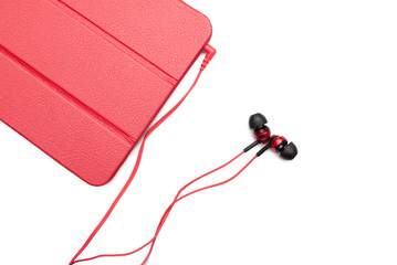 Red tablet and earphone plugs