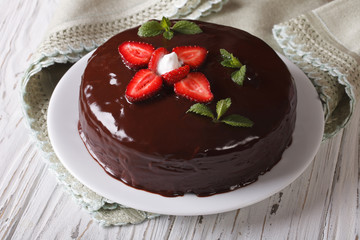 Fresh strawberry cake with chocolate topping horizontal close-up
