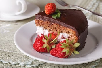 piece of chocolate cake with strawberries on a plate closeup
