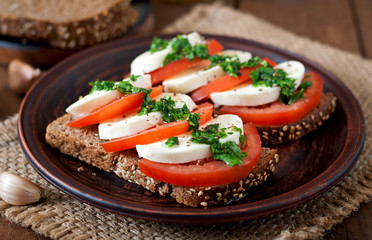 Useful dietary sandwiches with mozzarella, tomatoes and rye bread