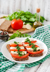 Useful dietary sandwiches with mozzarella, tomatoes and rye bread