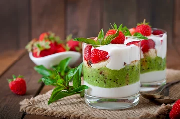 Gartenposter Creamy dessert with strawberries and kiwi © timolina