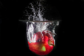 Apple in water on a black background