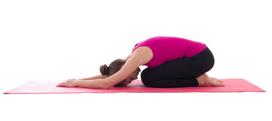 young woman doing stretching exercise on yoga mat isolated on wh