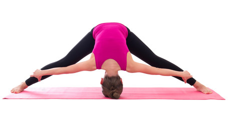 slim woman doing stretching exercise on yoga mat isolated on whi