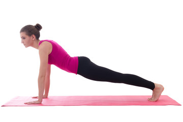 young beautiful woman doing push up exercise on yoga mat isolate