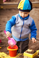 Boy Playing in Sandbox