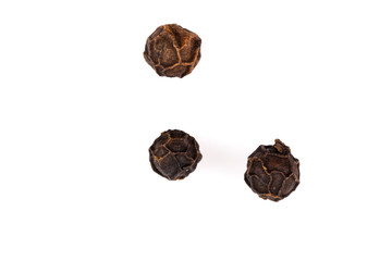 Black pepper seeds on white
