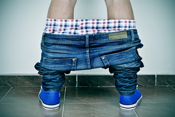 young man with his pants down seen from behind