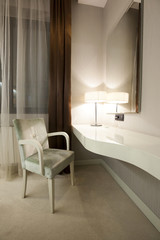 Wall desk and armchair in bedroom