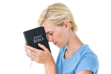 Pretty blonde woman holding bible