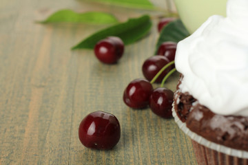 Chocolate Cupcakes with cherries on wooden background