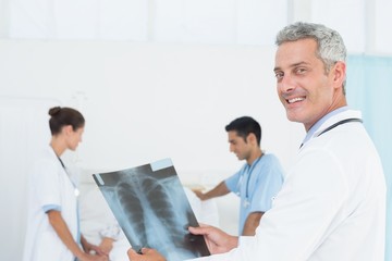 Male and female doctors examining x-ray