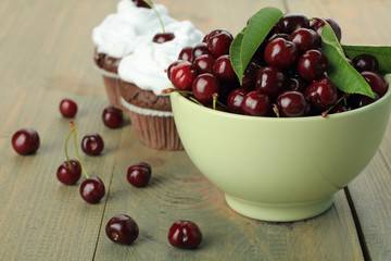 Chocolate Cupcakes with cherries on wooden background