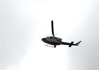 Italian police helicopter flying over the city