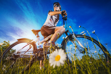 Woman is riding bicycle outside