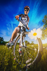 Woman is riding bicycle outside