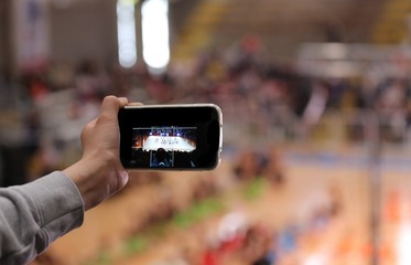 child photograph the show with the his smartphone