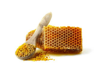 Honeycomb and a spoon with pollen. - obrazy, fototapety, plakaty