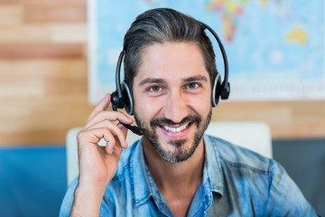 Smiling travel agent looking at camera