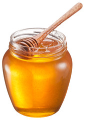 Glass can full of honey and wooden stick in it. Clipping paths.