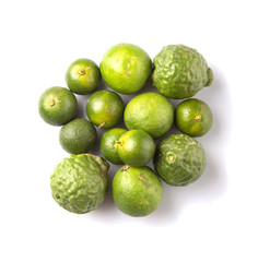 Lime, makrut or kaffir lime and calamansi over white background