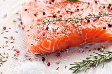 Salmon filet on a wooden carving board.