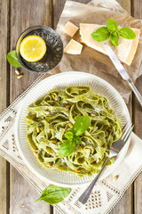 Homemade spinach pasta with pesto and Parmesan cheese