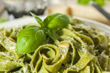 Homemade spinach pasta with pesto and Parmesan cheese