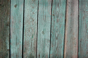 Wooden Palisade background. Close up of grey and green wooden fence panels. 